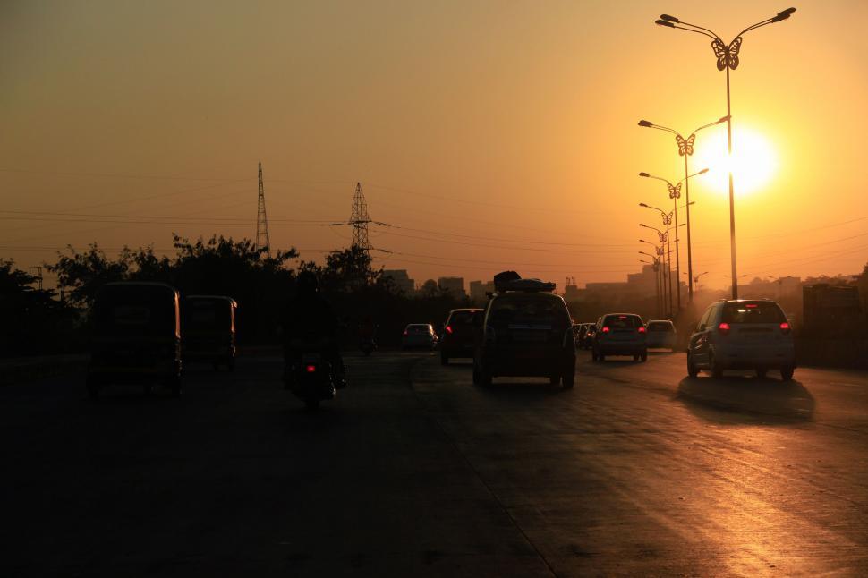 Free Image of Cars on road during sunset  