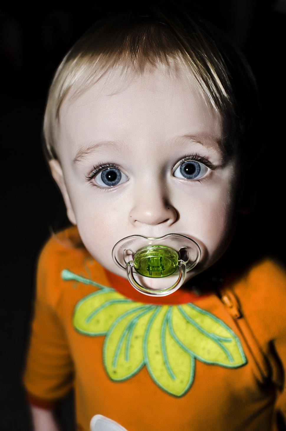 Free Image of Baby with air pacifier - looking at camera  