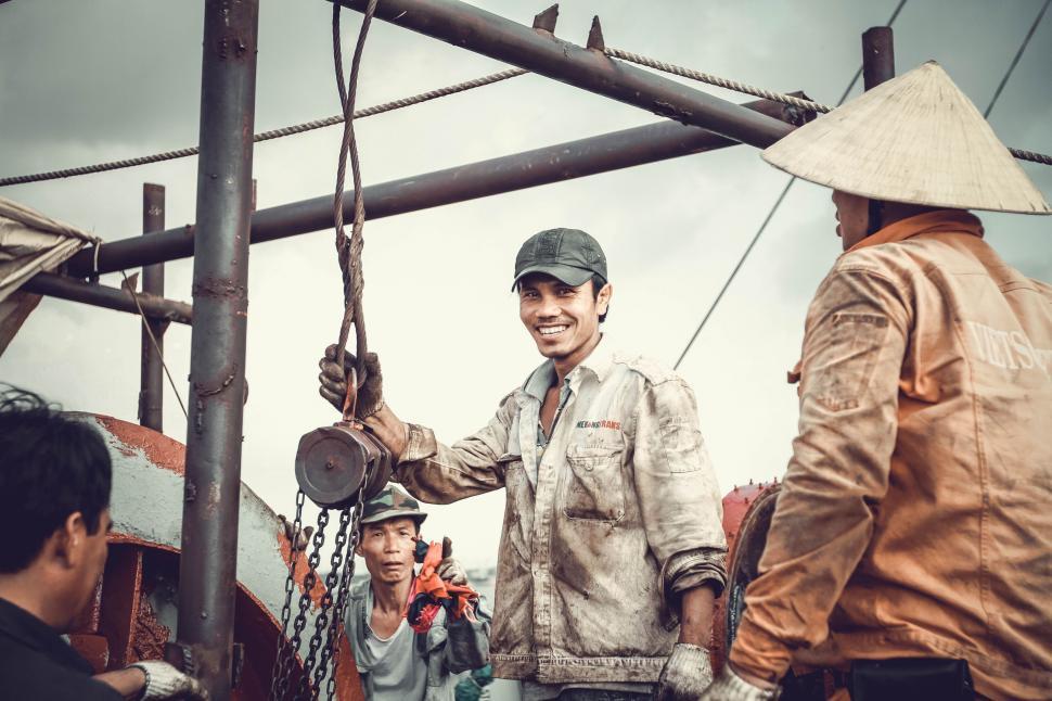 Free Image of Vietnamese Men on oil field 
