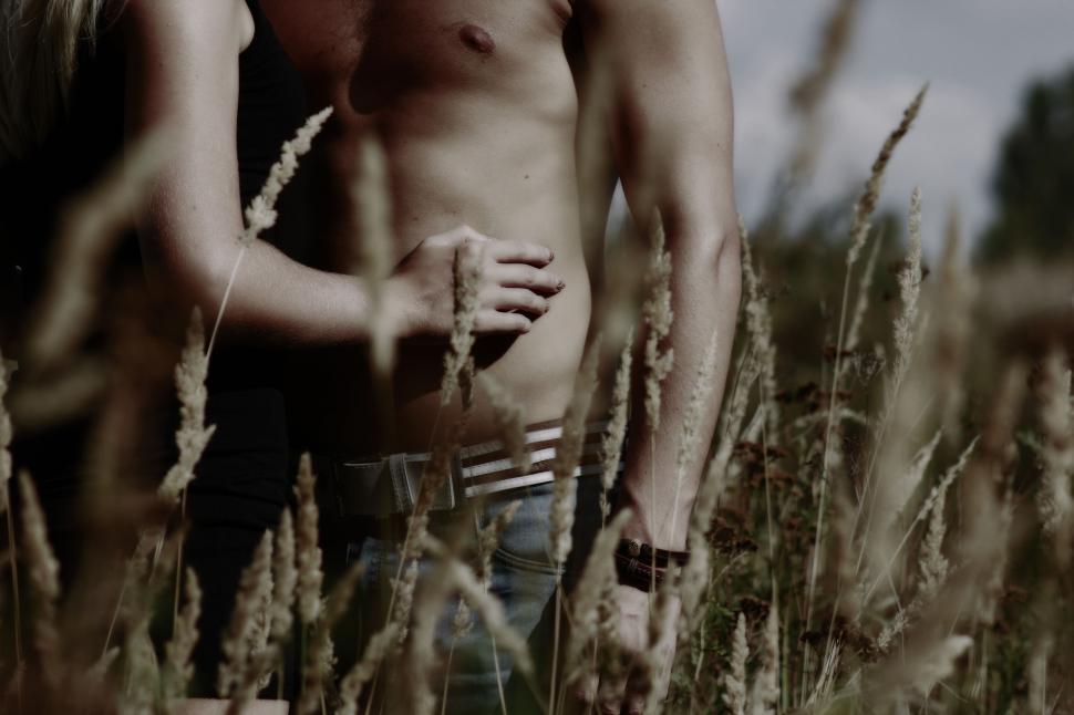 Free Image of Shirtless Man With Woman in Grass Field 