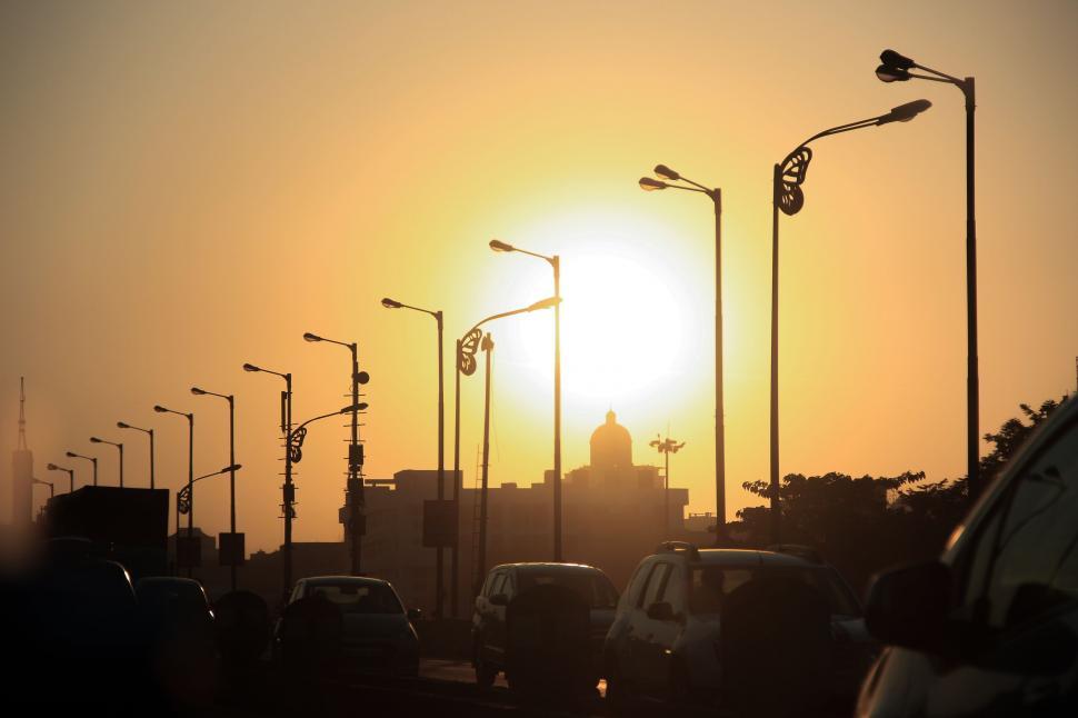 Free Image of Street Lights and Sunset With Cars on Road  