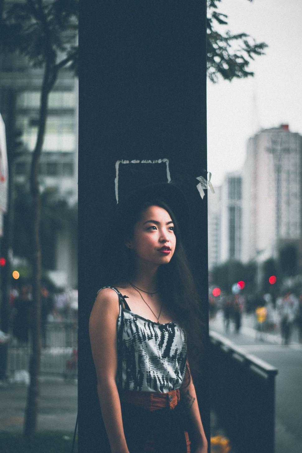 Free Image of Young Asian Woman With Blur Bokeh Road in the background  
