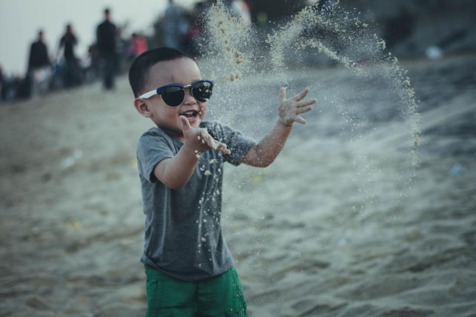 Free Image of Little Boy Playing with Beach Sand 