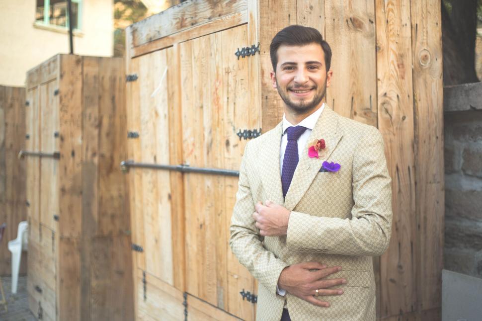 Free Image of Young Man in Beige Suit and Blue Tie 