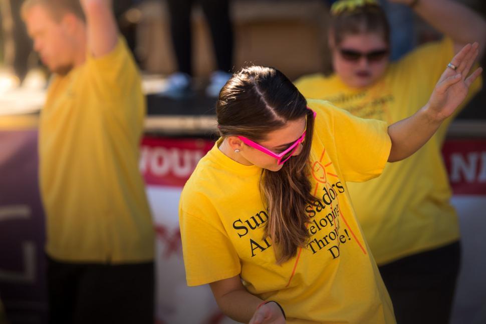 Free Image of People Wearing Yellow T-Shirts Dancing During Event  