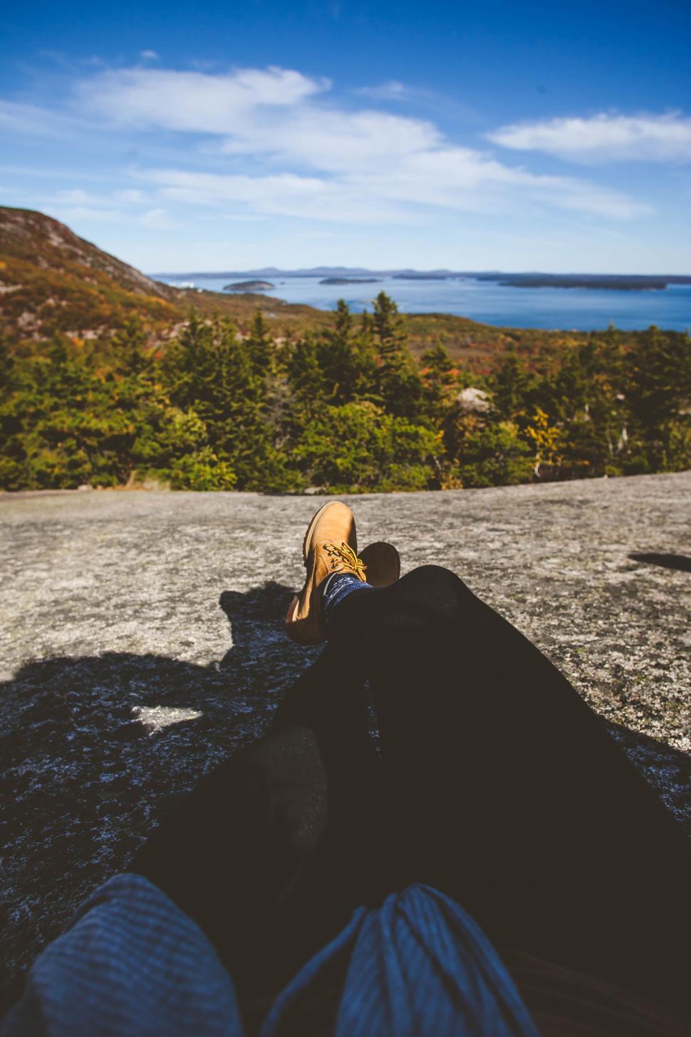 Free Image of Person lie on mountain in leather boots 