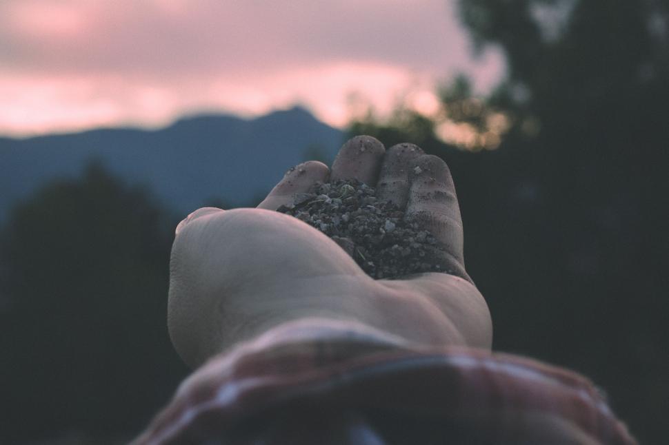 Free Image of Stones in hand During Sunset  