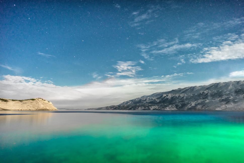 Free Image of Green Lake With Stars in Blue Sky 