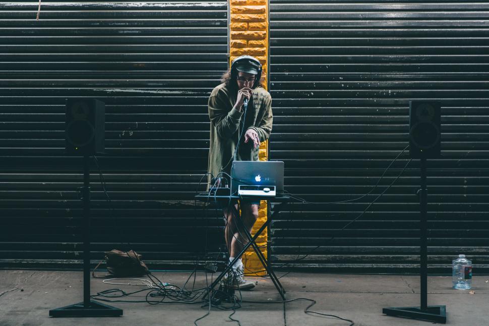 Free Image of Singer with laptop on street  