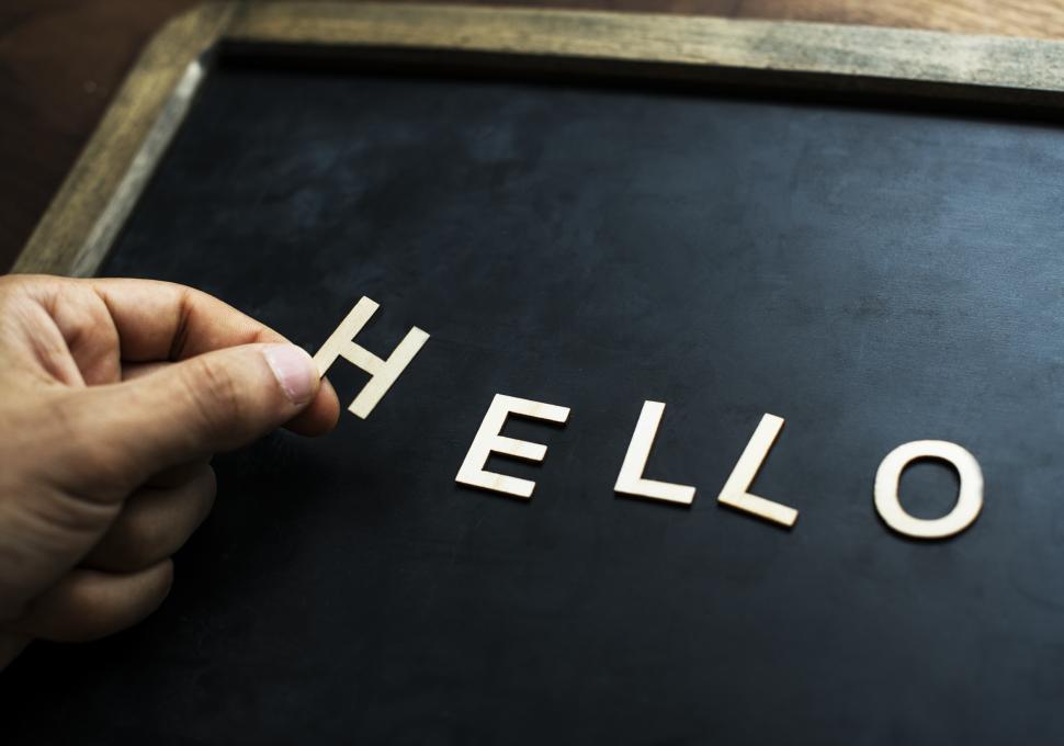 Free Image of Overhead view the word HELLO being arranged on a slate 