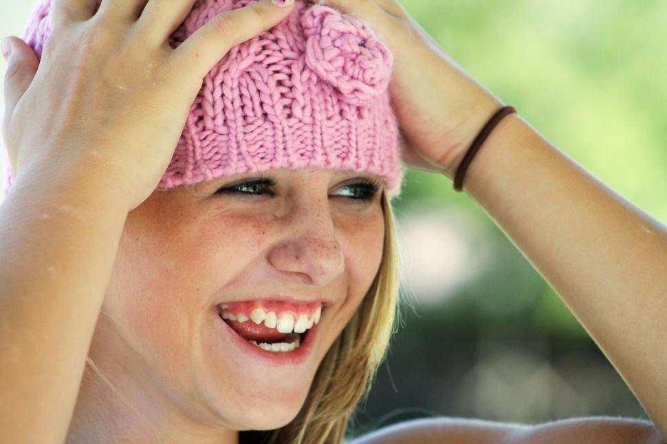 Free Image of Smiling Woman in Pink Knitted Cap 