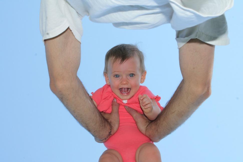 Free Image of Young Man Lifting His Little Daughter 