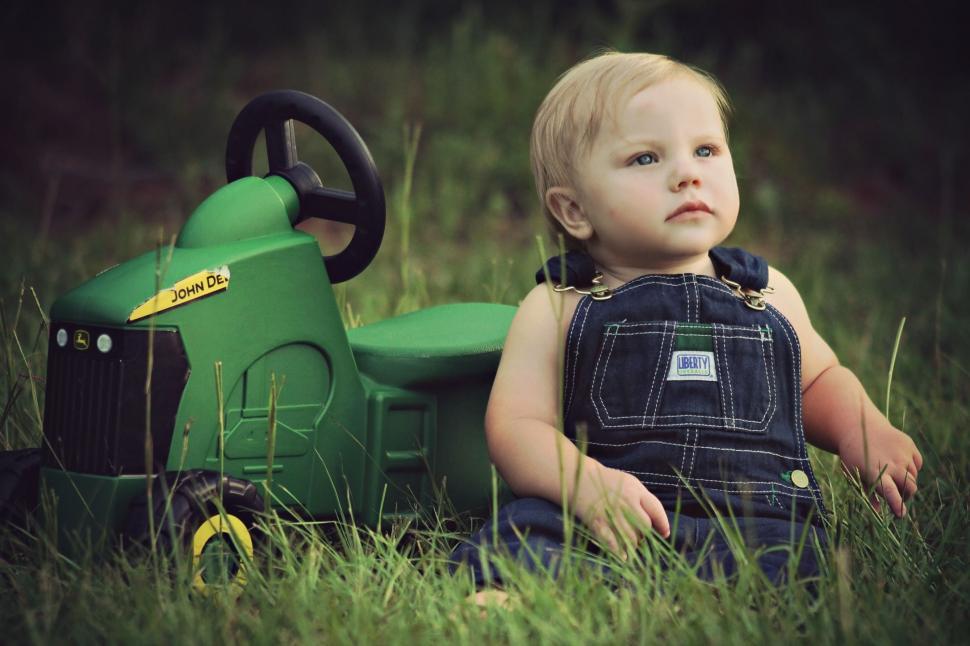 Free Image of Little Boy and Toy Tractor  
