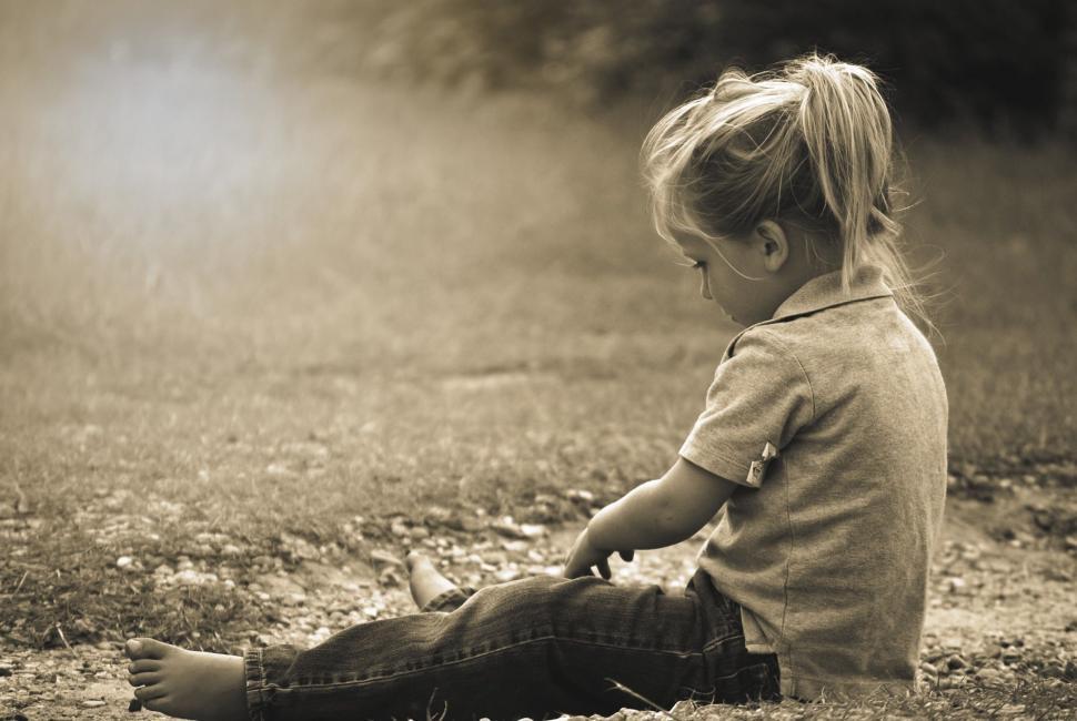Free Image of Little Boy sitting in park - Monochrome  