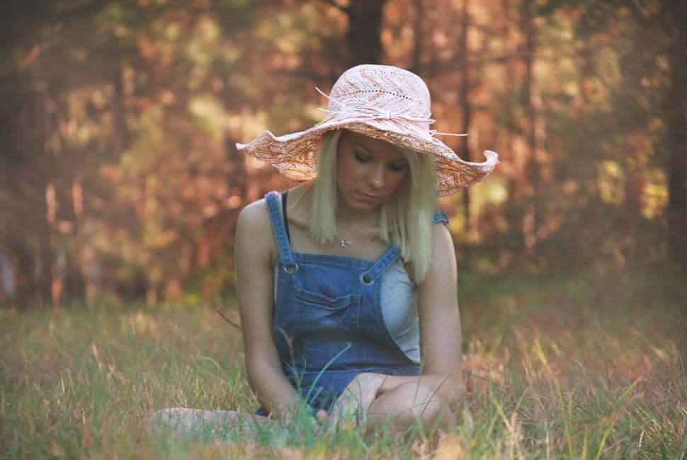Free Image of Teenage Girl Sitting on Green Grass - Looking Down  