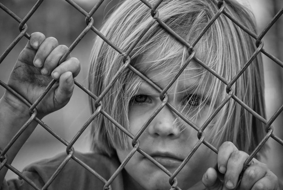 Free Image of Little Boy and chain link fence - B&W 