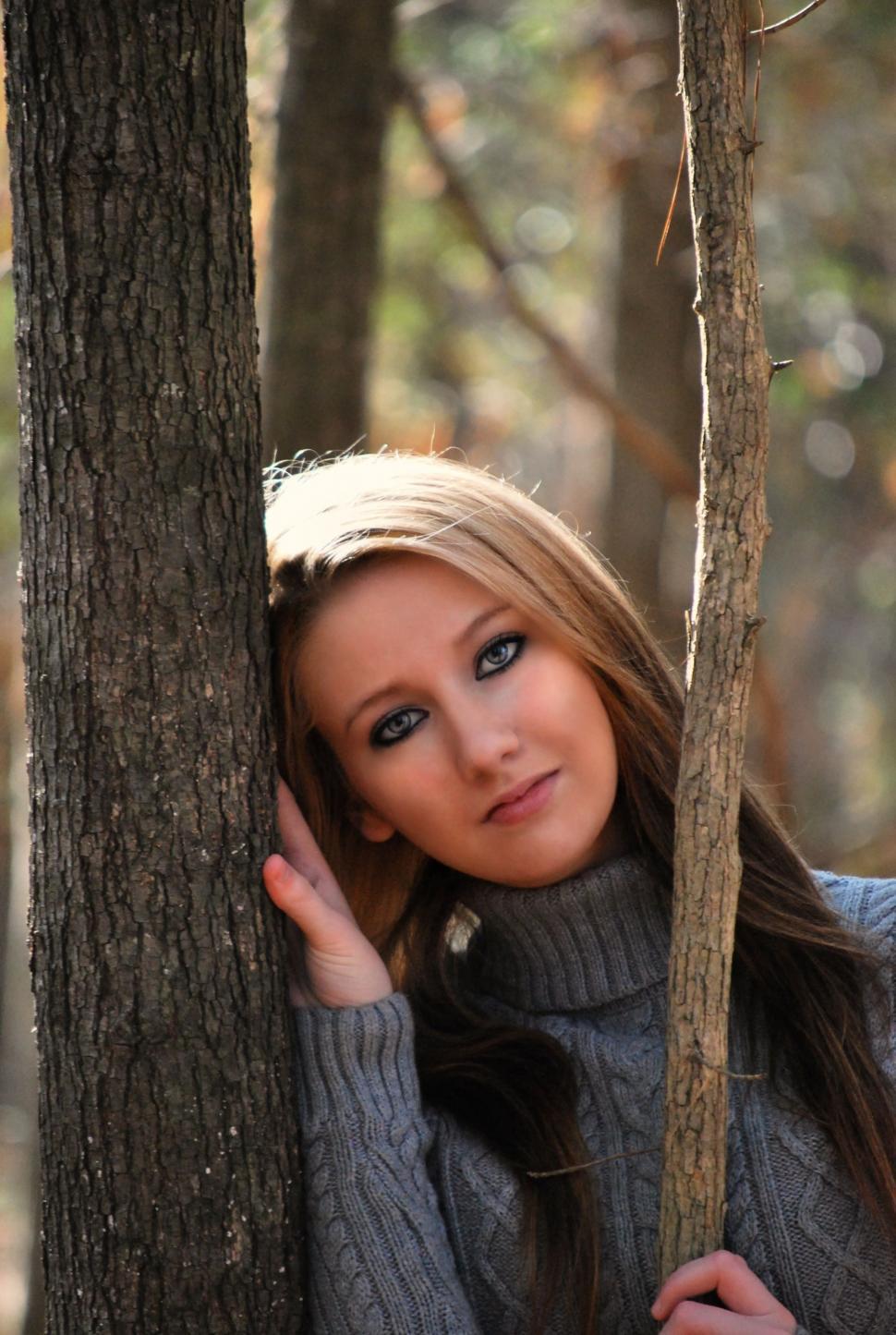 Free Image of Young Stylish Woman Leaning on Tree - looking at camera 