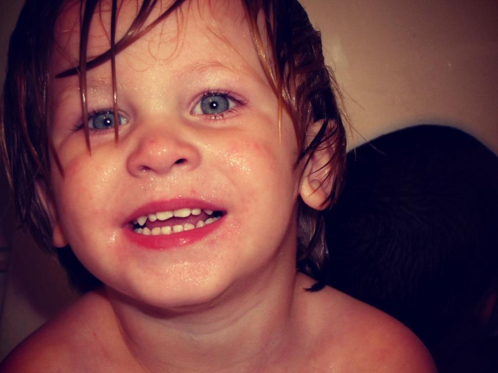 Free Image of Smiling Little Boy With Wet Face  