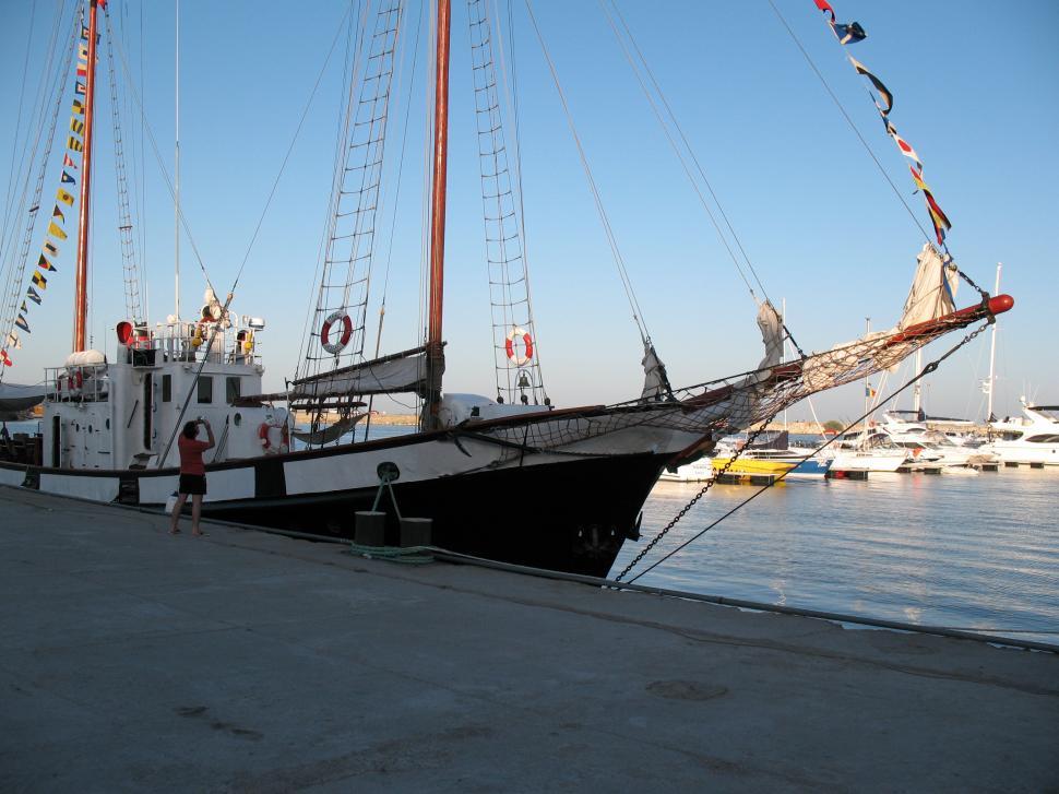 Free Image of Large sailing ship at the dock  small yachts in the background 
