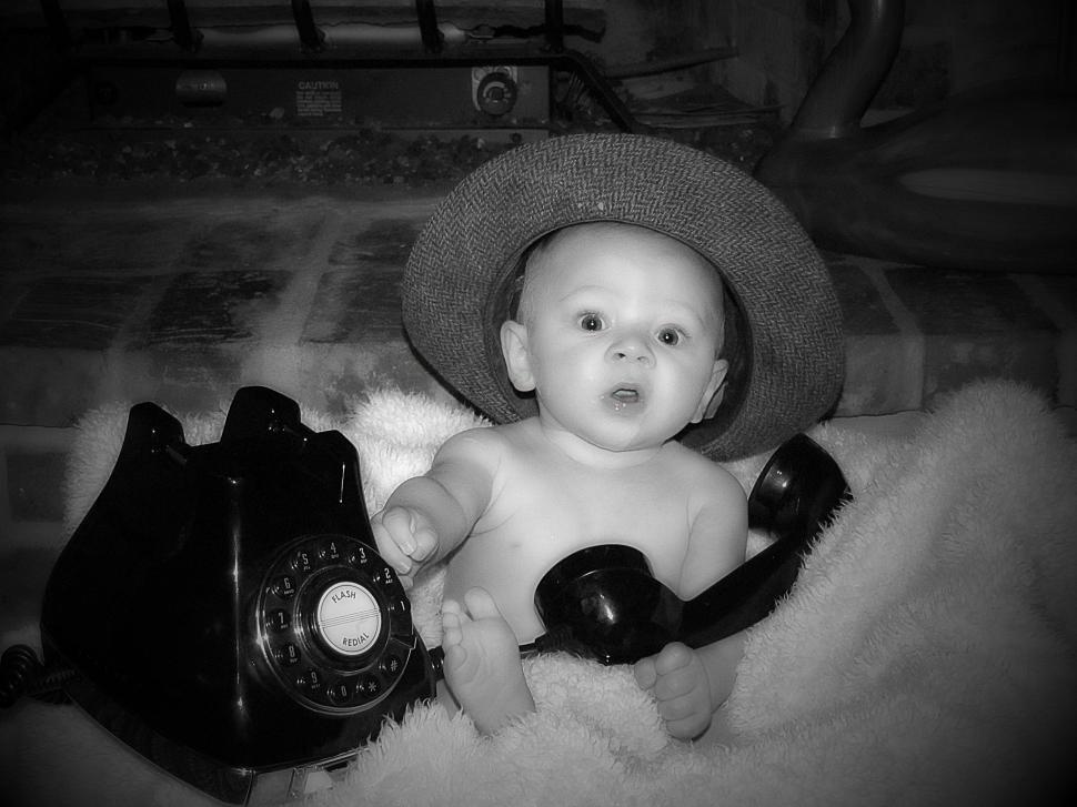 Free Image of Little Baby With Old Telephone  