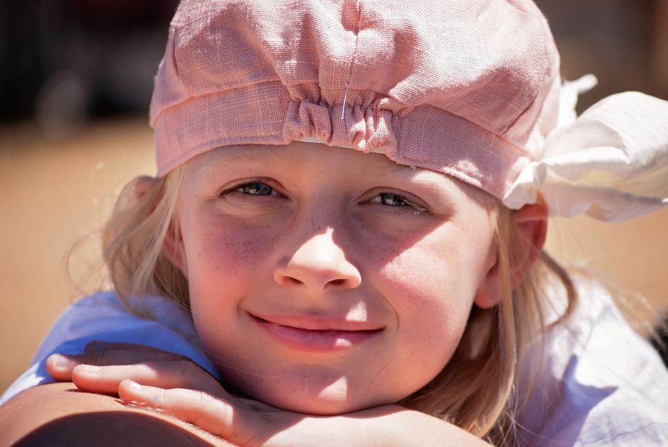 Free Image of Smiling Teenage Girl in Pink Cap 
