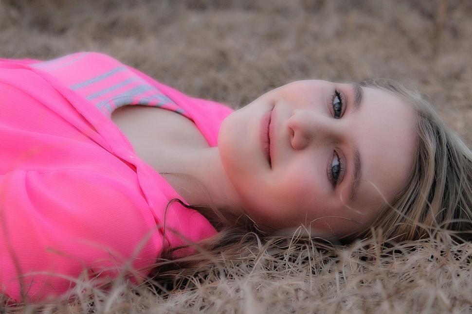 Download Free Stock Photo of Smiling Teenage Girl Lying On Grass  