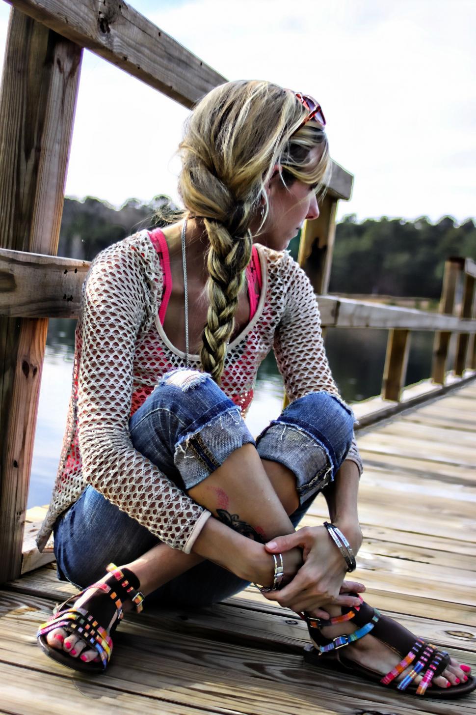 Free Image of Woman with braided hair on wooden pier  