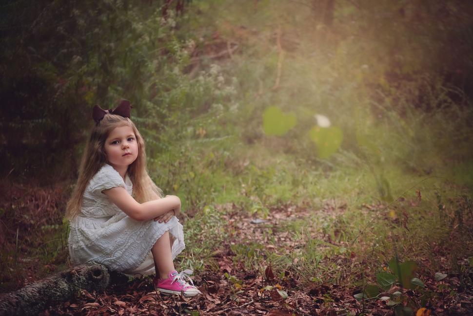 Free Image of Little Girl in White Dress In Woods 