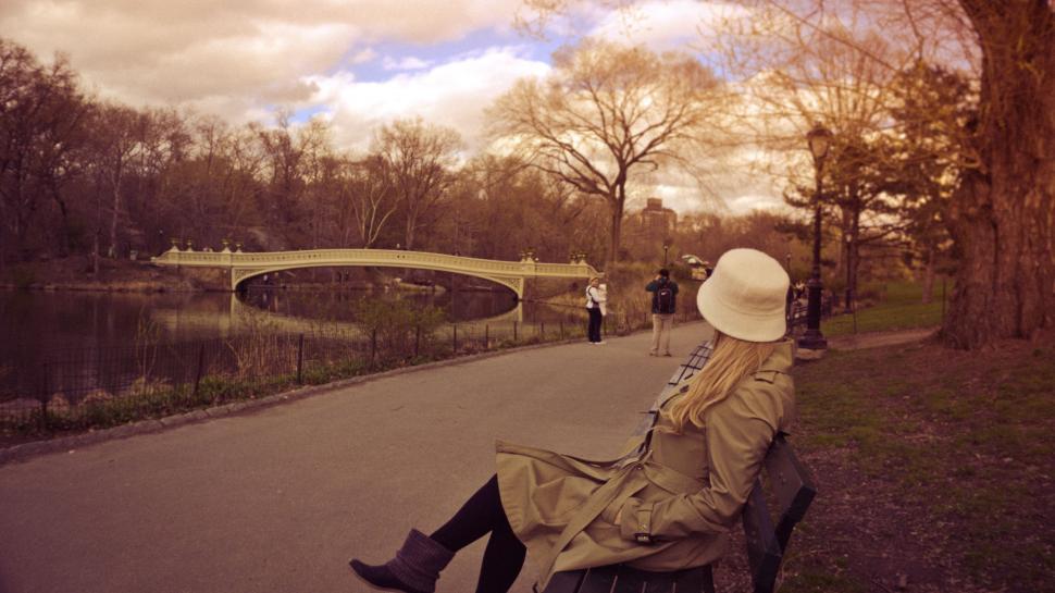 Free Image of Blonde woman sitting on bench at Central Park 