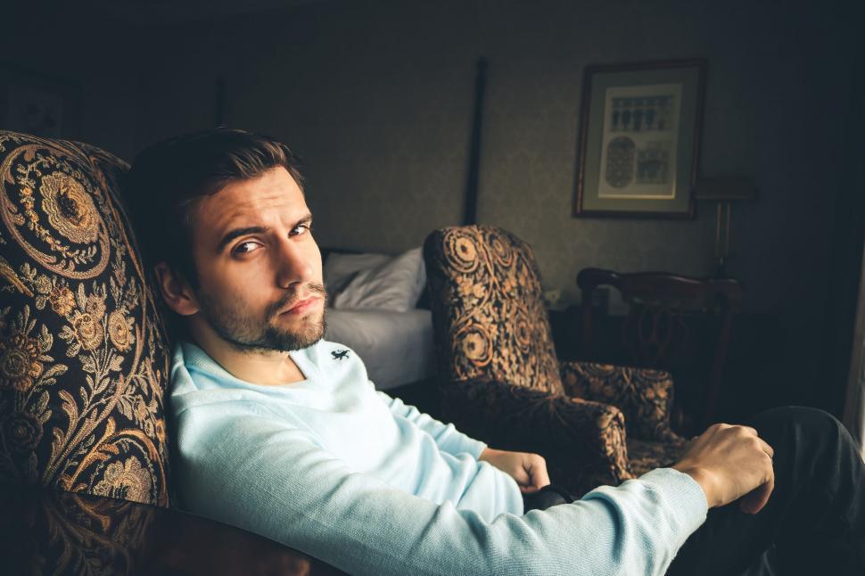 Free Image of Portrait of Young Man With Stubble Beard on Chair - Eye Contact  
