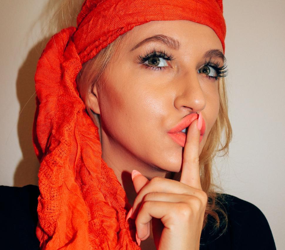 Free Image of Stylish Woman with finger on mouth - keeping secret  