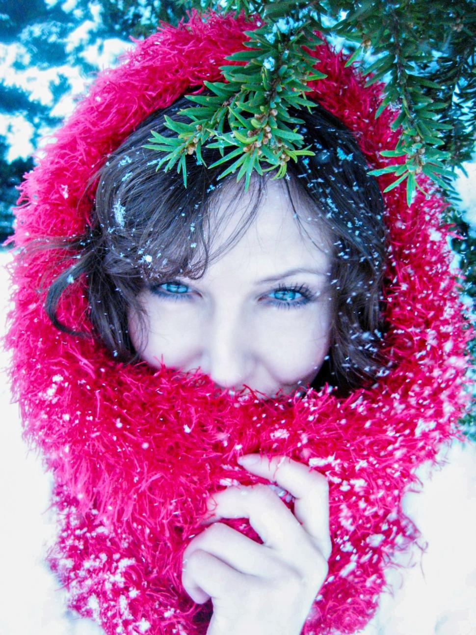 Free Image of Woman With Mistletoe leaves and Snowfall - looking at camera  