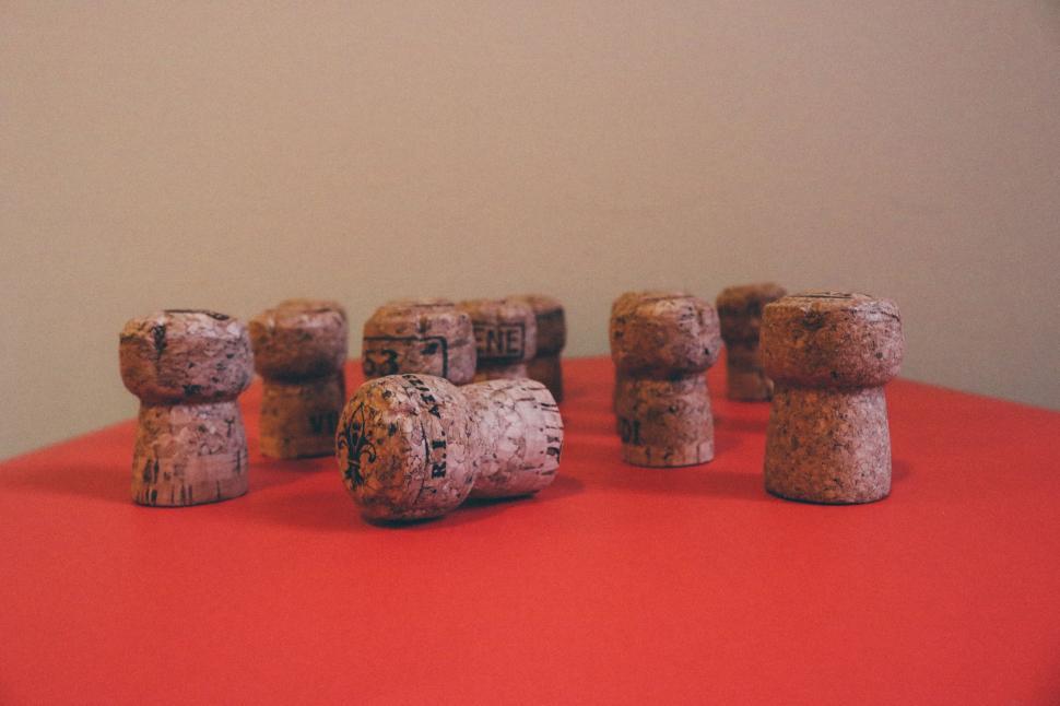 Free Image of Wine corks on red table  