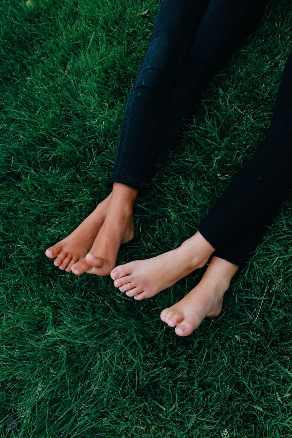 Free Image of Two Pair Of Female Feet on Grass 