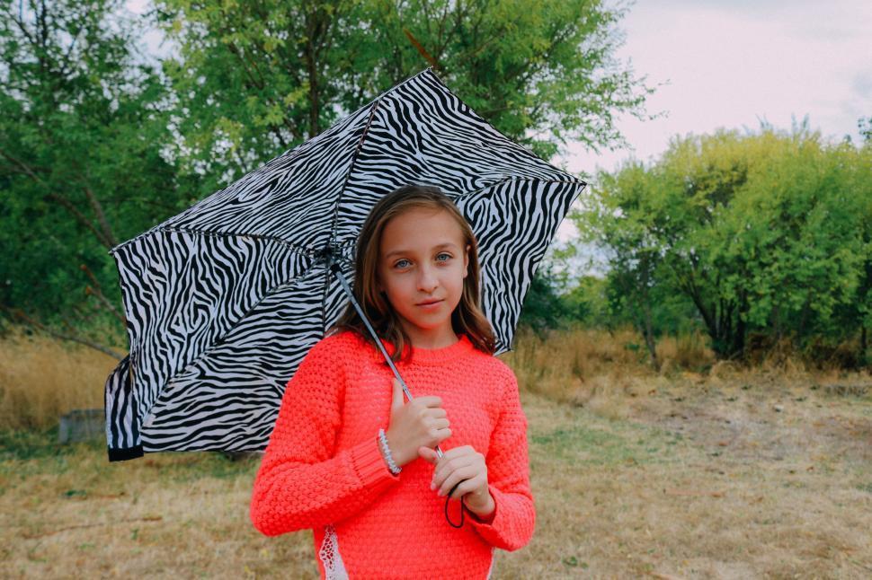 Free Image of Young Girl With Umbrella - looking at camera  