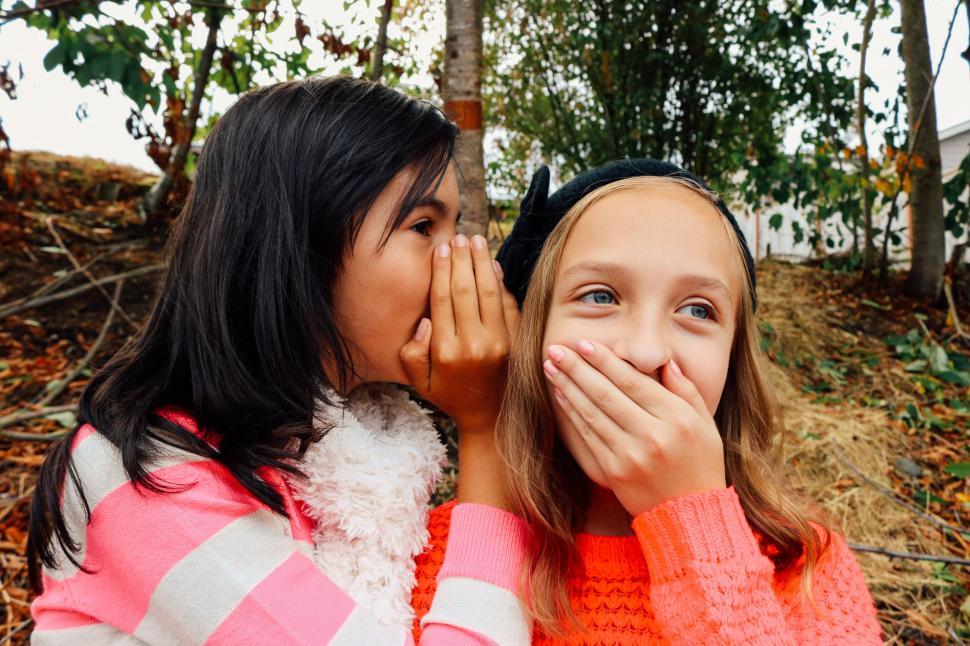 Download Free Stock Photo of Two young girls whispering 