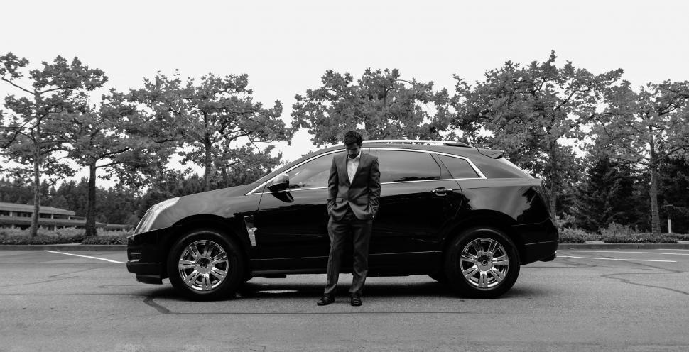 Free Image of Businessman With Car and Trees - B&W 