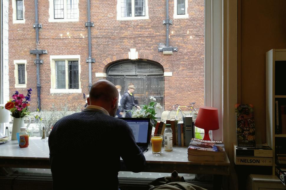 Free Image of Man Sitting at Desk by Window 