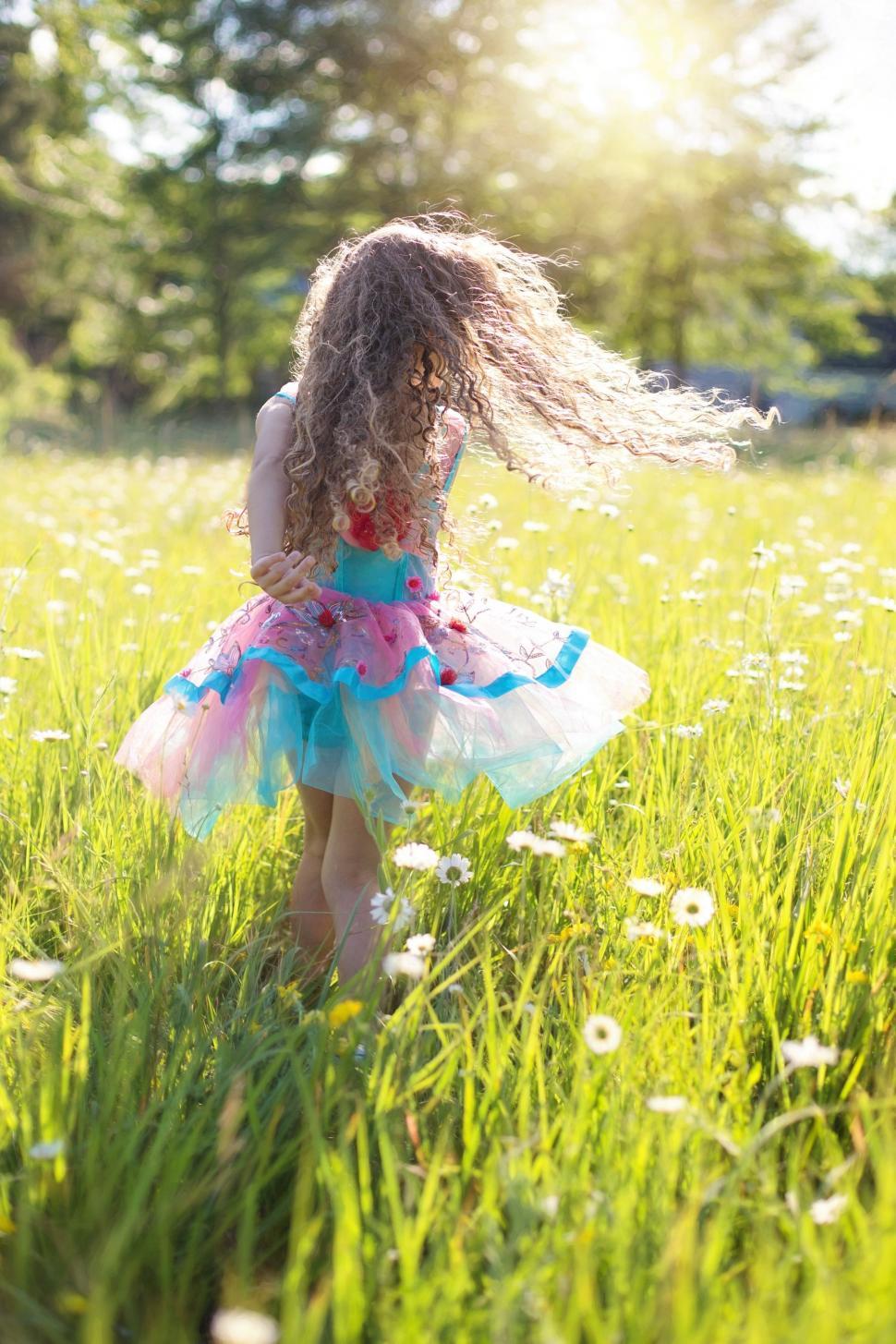 Free Image of Little Girl dancing in flower field  