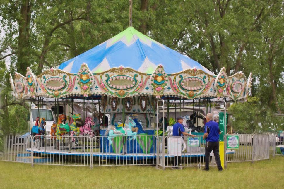 Free Image of Carousel roundabout ride and green grass - Day View 