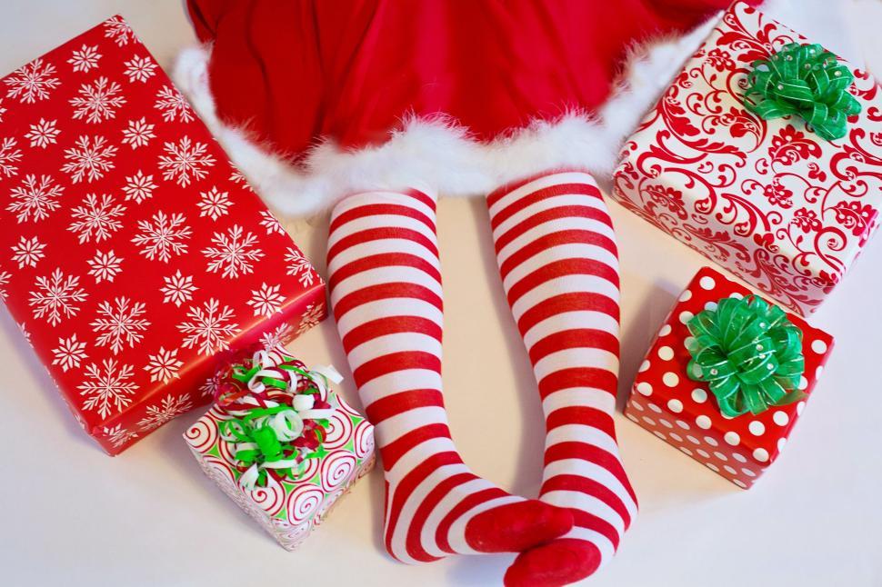 Free Image of Girl in red white striped Christmas socks  