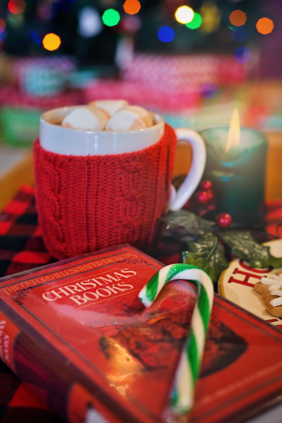Free Image of Red Christmas Book and Green Striped Candy Cane 