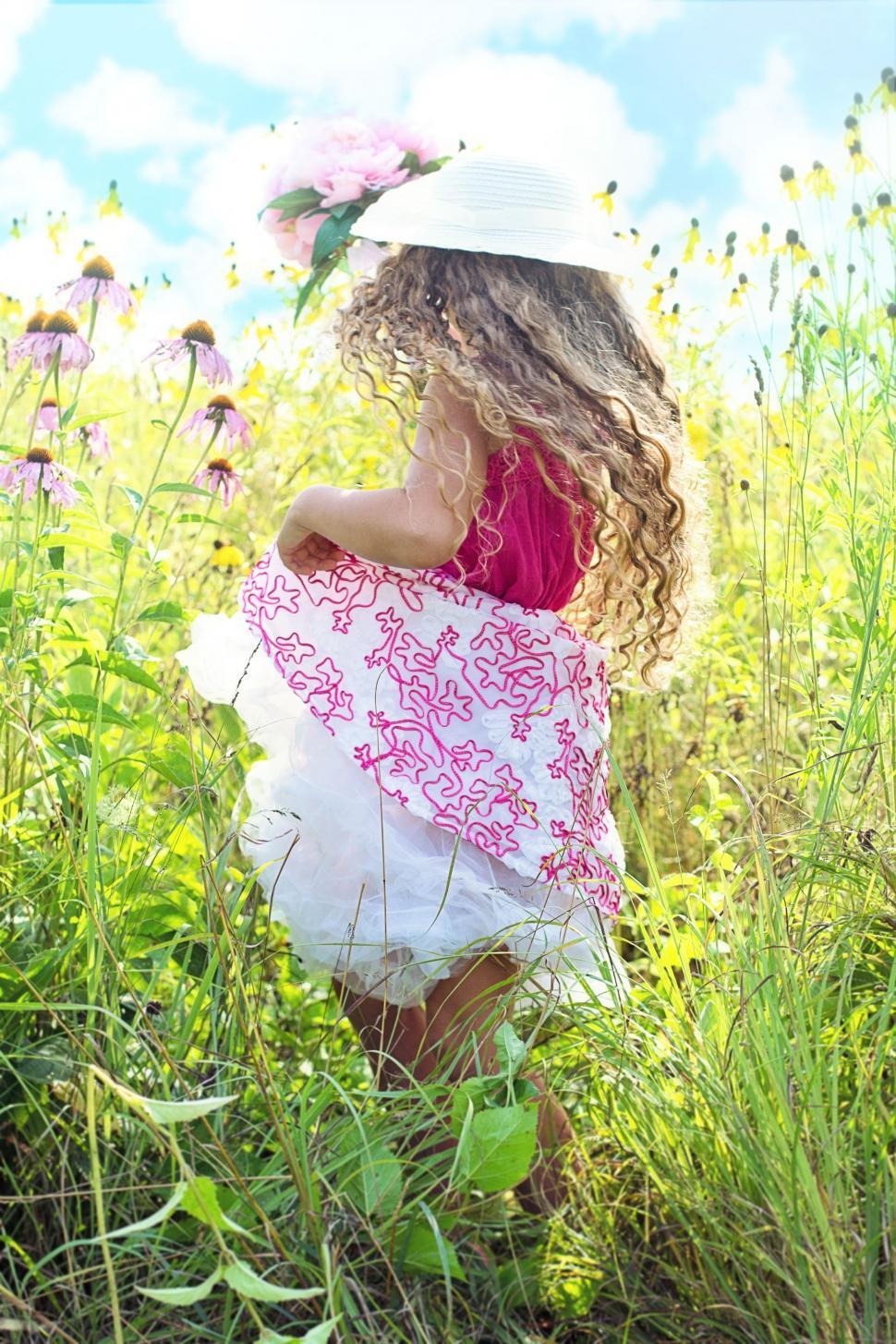 Free Image of Little Girl in White Hat Running In Meadow  