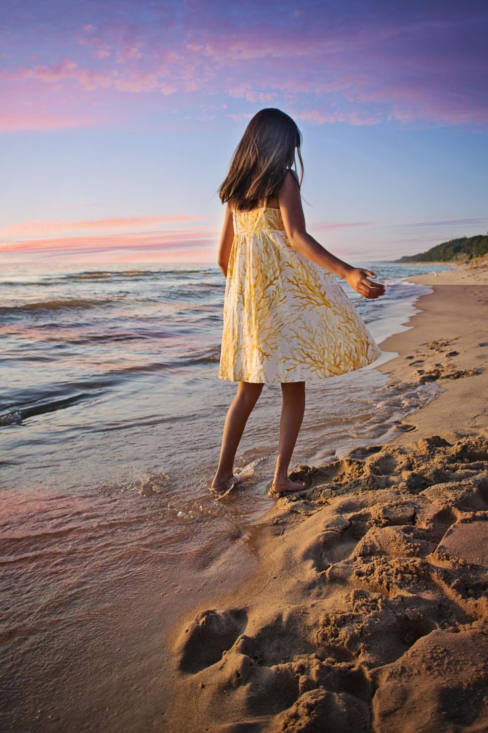 Free Image of Back View of Girl strolling at the beach 