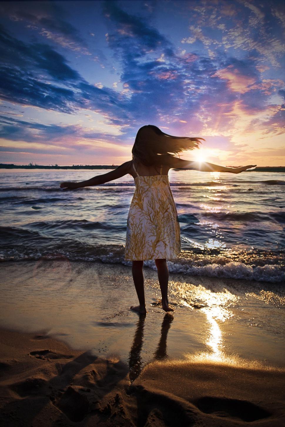 Free Image of Rear View of Girl dancing at the beach 