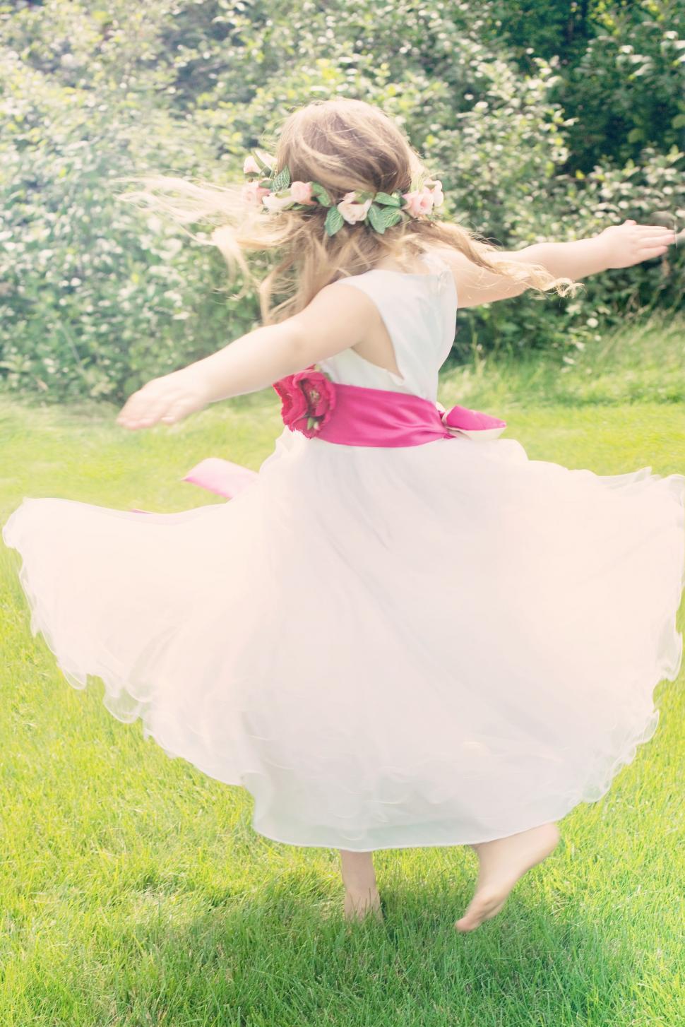 Free Image of Little Girl dancing in the park 
