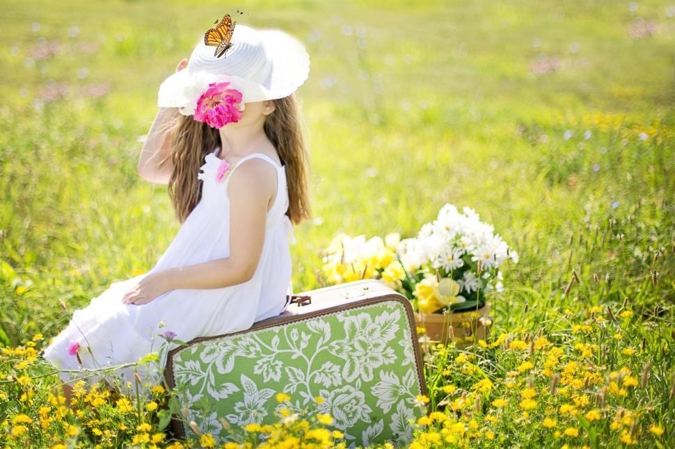 Free Image of Little Girl With Suitcase in Flower Field  