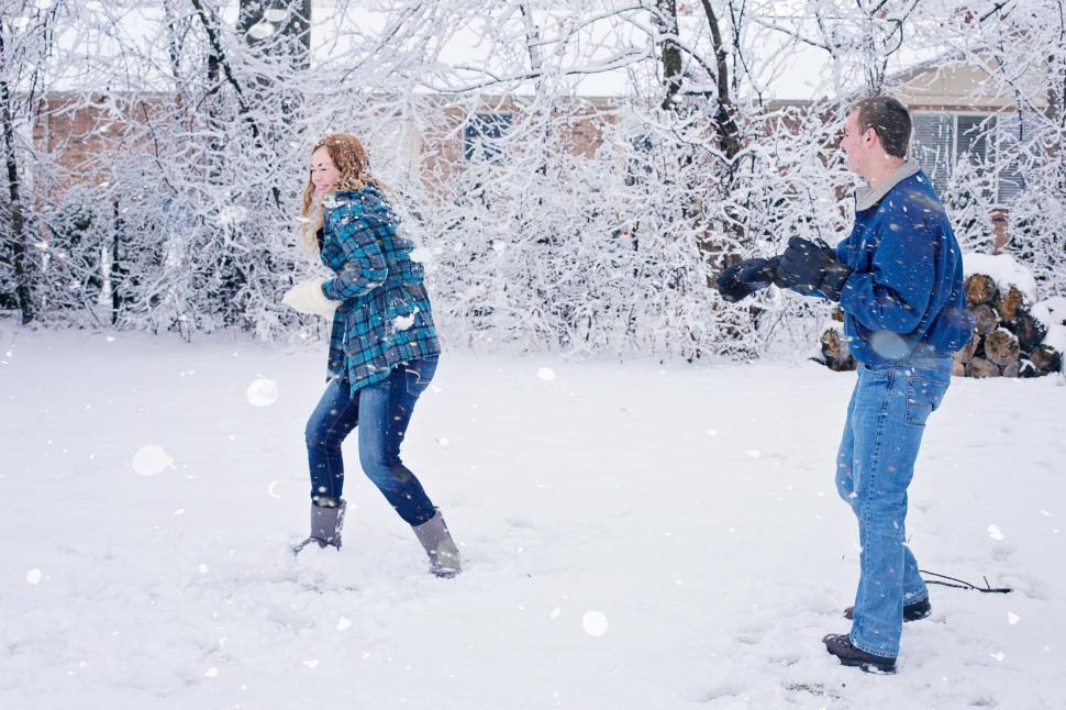 Free Image of Couple Playing With Snowballs  