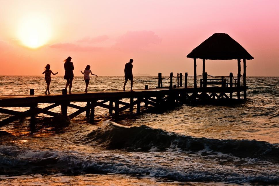 Free Image of Family Standing on Pier at Sunset 