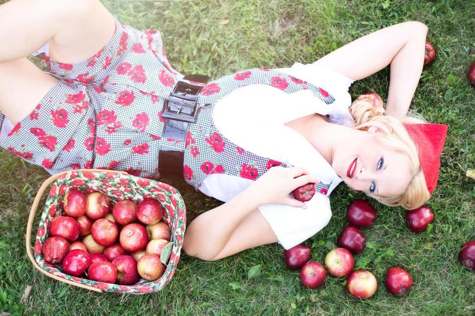 Free Image of Stylish Woman With Basket of Apples on Grass - Looking at camera  